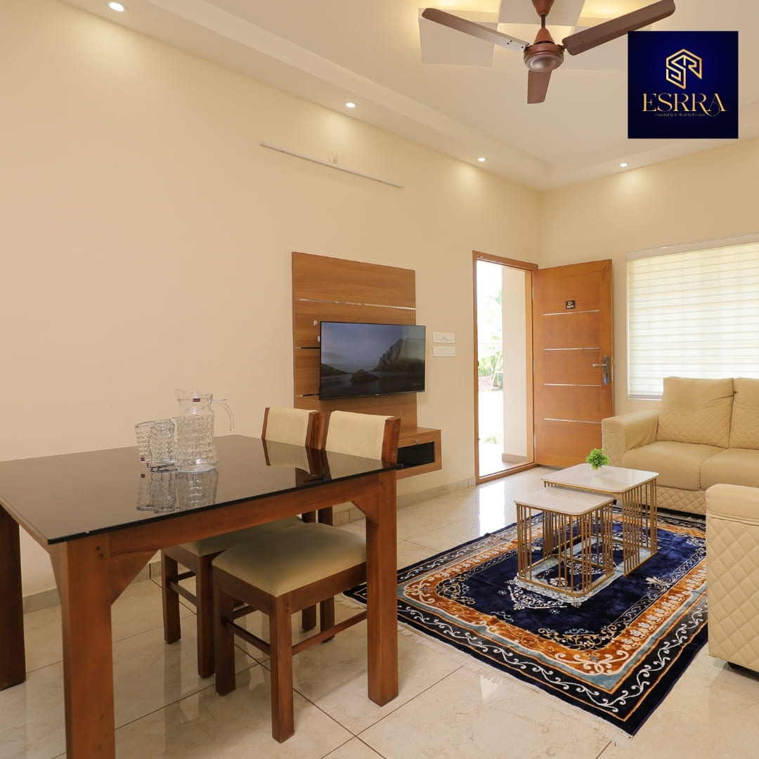 Best 2BHK daily rent flat in Ernakulam featuring a warm and welcoming living room with modern TV units; couple and family friendly luxury stay with fully equipped kitchen, 24hr check-in, and free WiFi for business travellers.
