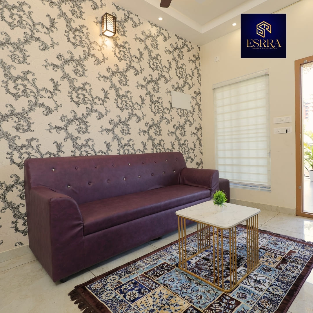 Modern living room with purple sofa and gold coffee table in Ernakulam service apartment